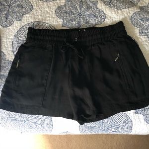 Black tuxedo shorts with zipper pockets on front